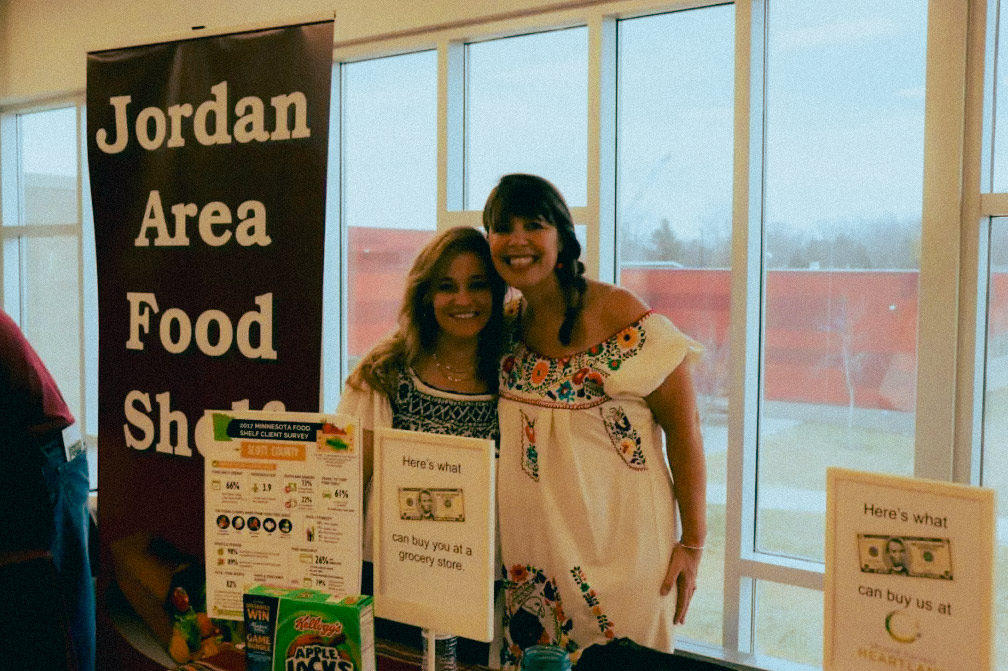 Tanya Velishek and friend smiling as the host the Jordan food shelf initiative.